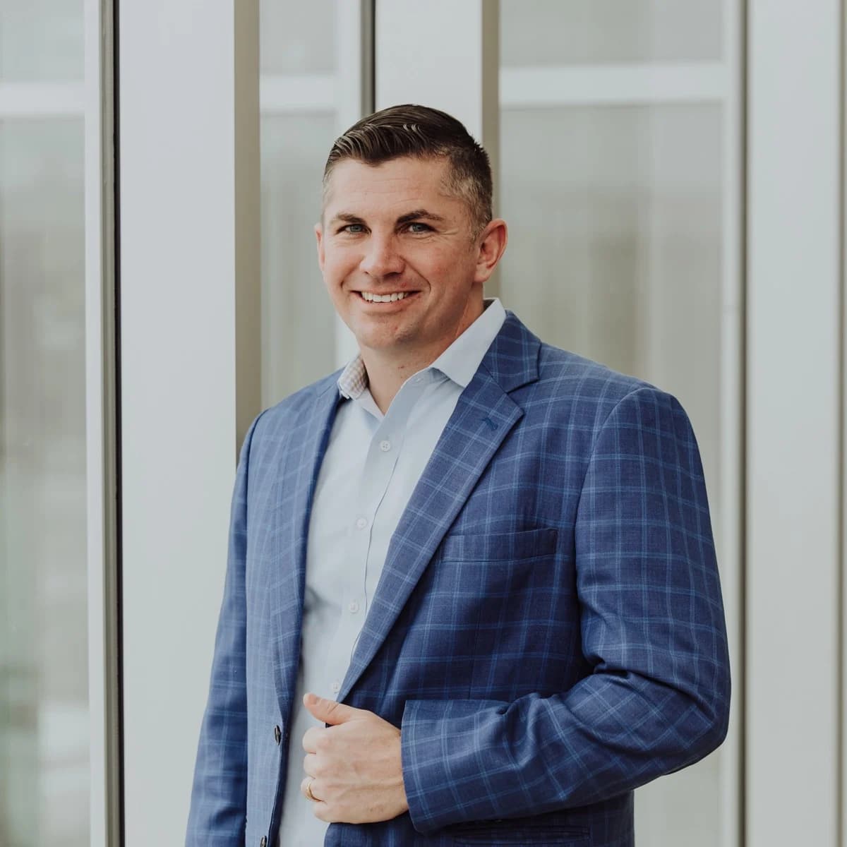 Rennie Barton, REALTOR® / Owner of City2Shore Arete Collection, in a blue suit