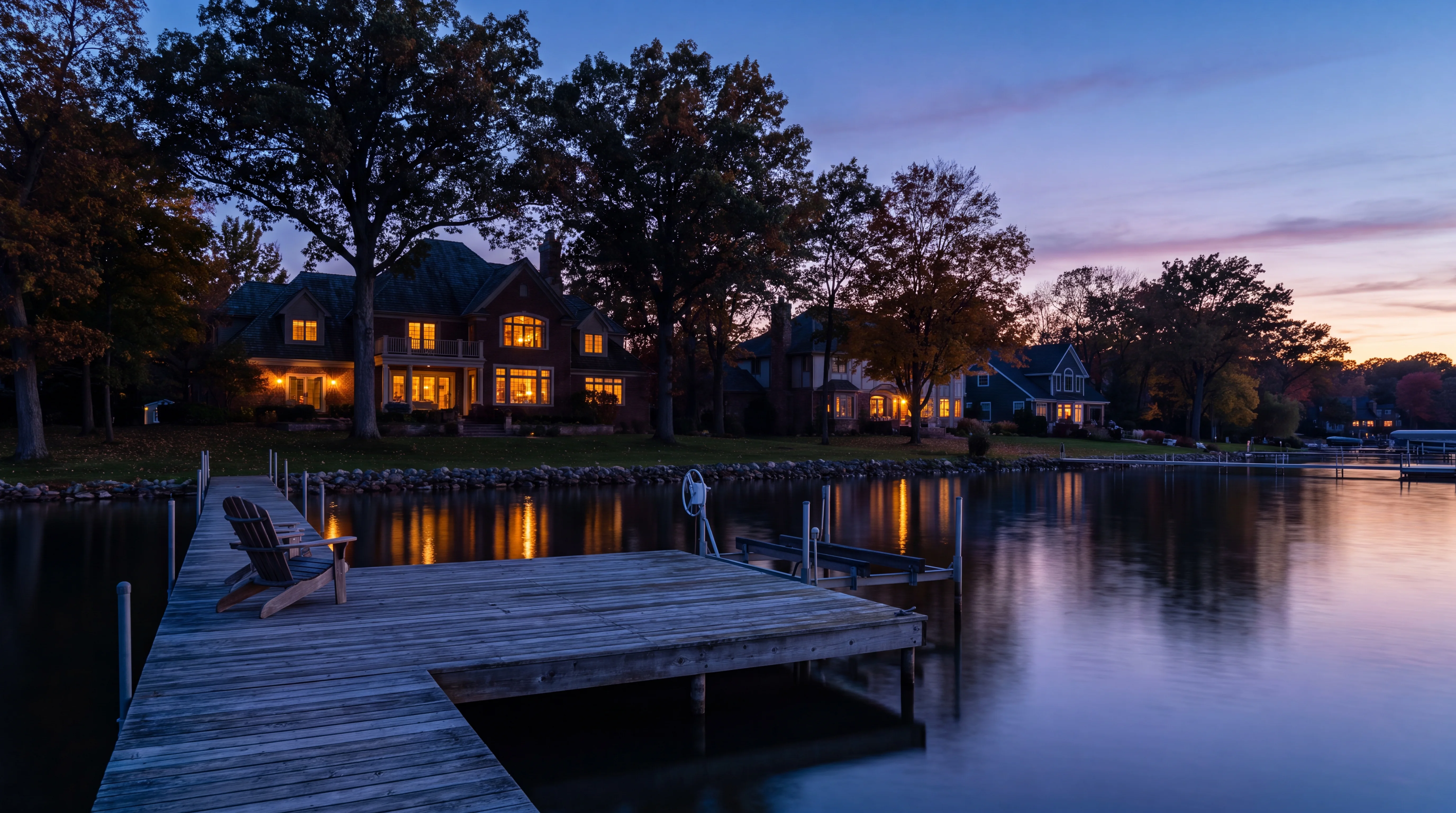 Established homes along a calm inland lake at dusk